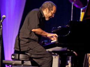 Nat Adderley sits at piano & plays