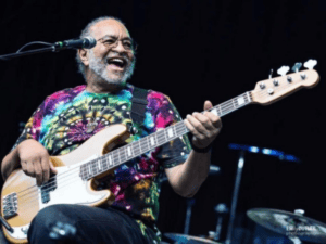 George Porter, Jr. performing on stage with his bass