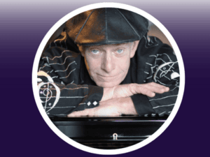 Image of Dave Keyes leaning over a piano